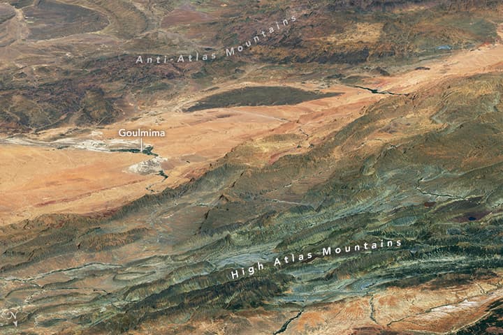 View of the High Atlas Mountains showing exposed rock formations and geological layers, illustrating Morocco's tectonically active terrain